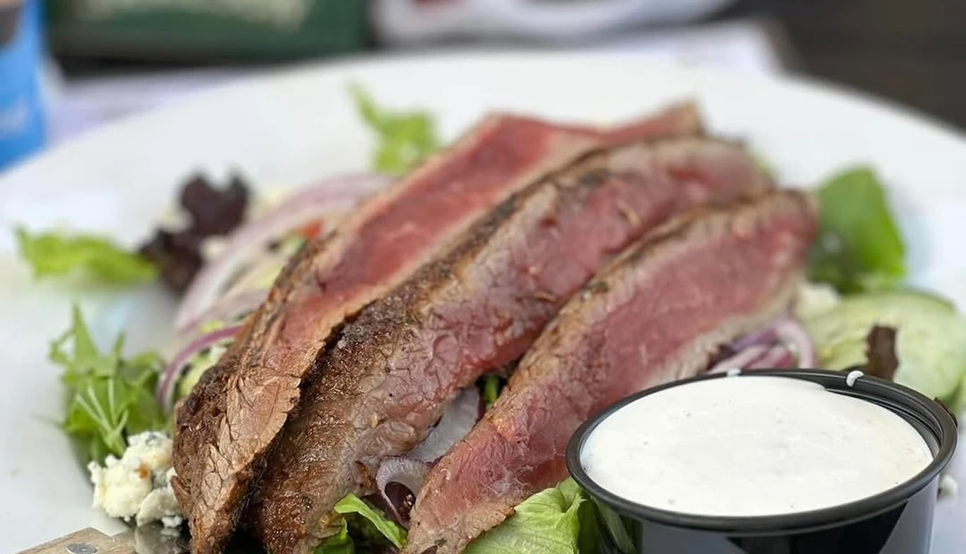 Sliced steak salad with dressing at McNamara's Pub & Restaurant, Irish pub near Alexandria VA