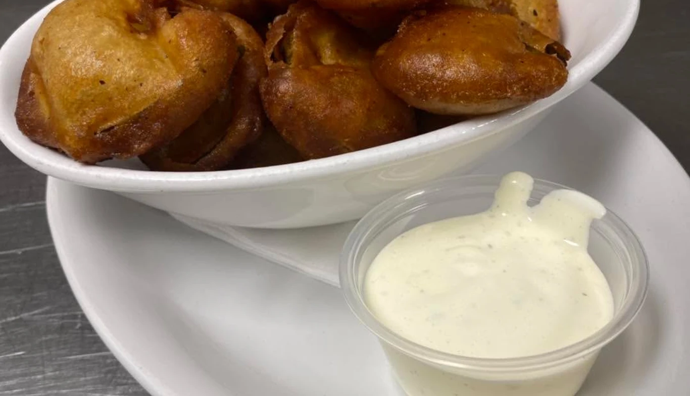 Crispy potato bites with a side of dipping sauce at McNamara's Pub & Restaurant, Irish pub near Arlington Ridge VA