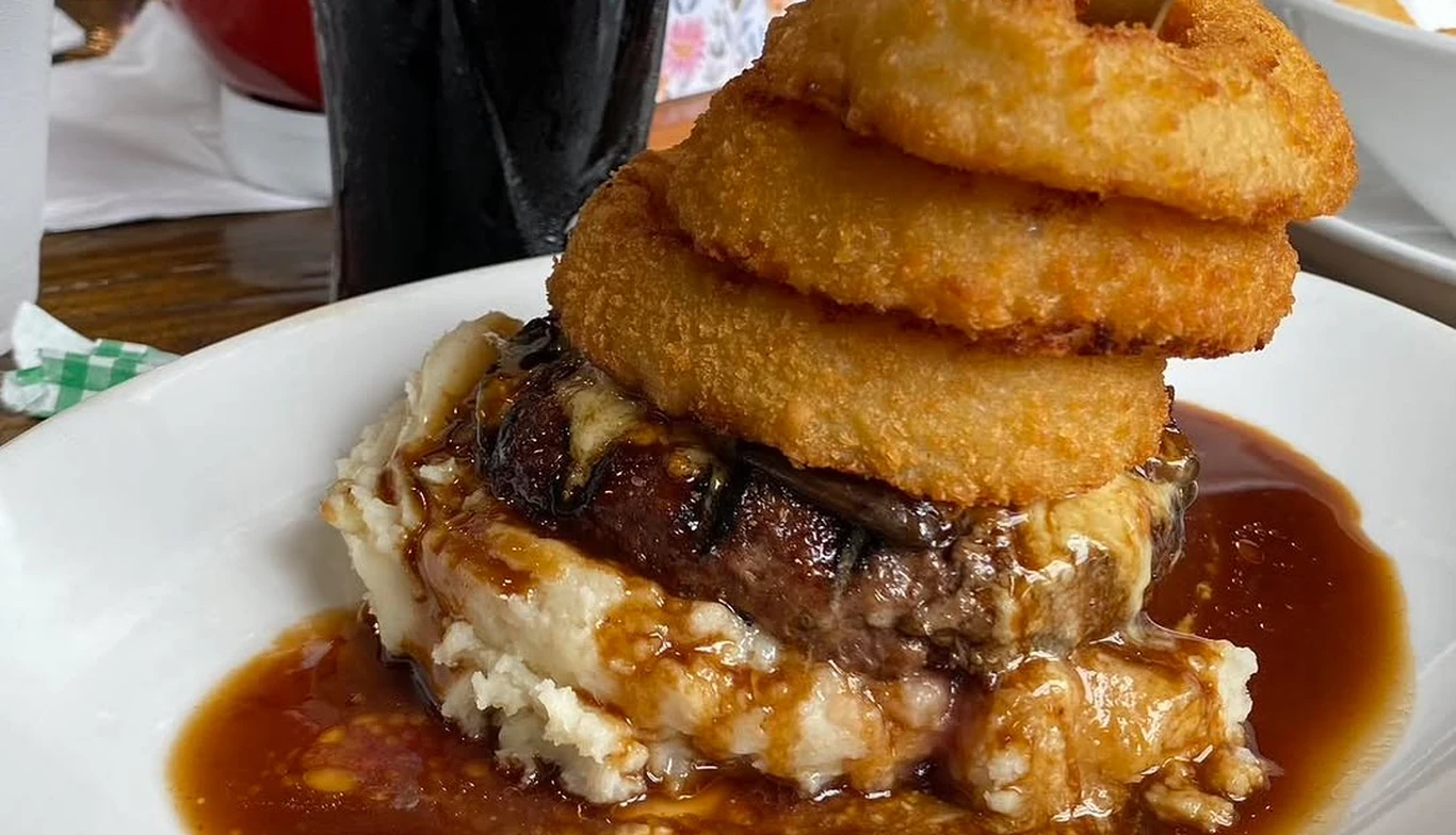 Burger topped with onion rings and gravy at McNamara's Pub & Restaurant, Irish pub near Arlington Ridge VA