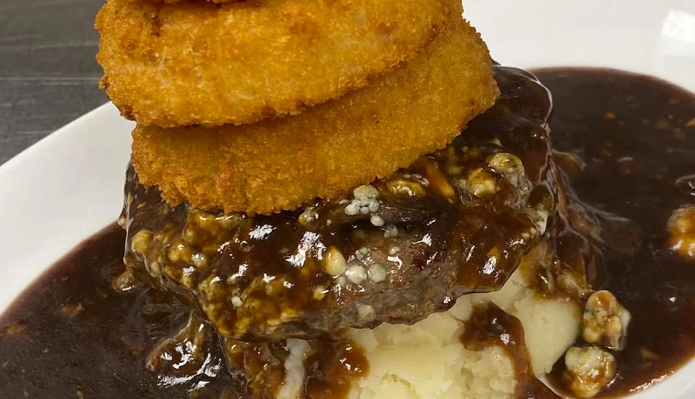 Burger topped with onion rings and gravy at McNamara's Pub & Restaurant, Irish pub near Crystal City VA